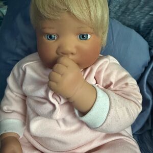 Realistic Baby Doll in Light Pink Pajamas with Blue Eyes